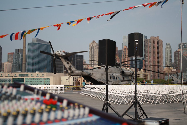 CitiView AV outdoor event production on Intrepid aircraft carrier NYC with audio equipment white chairs and NYC skyline