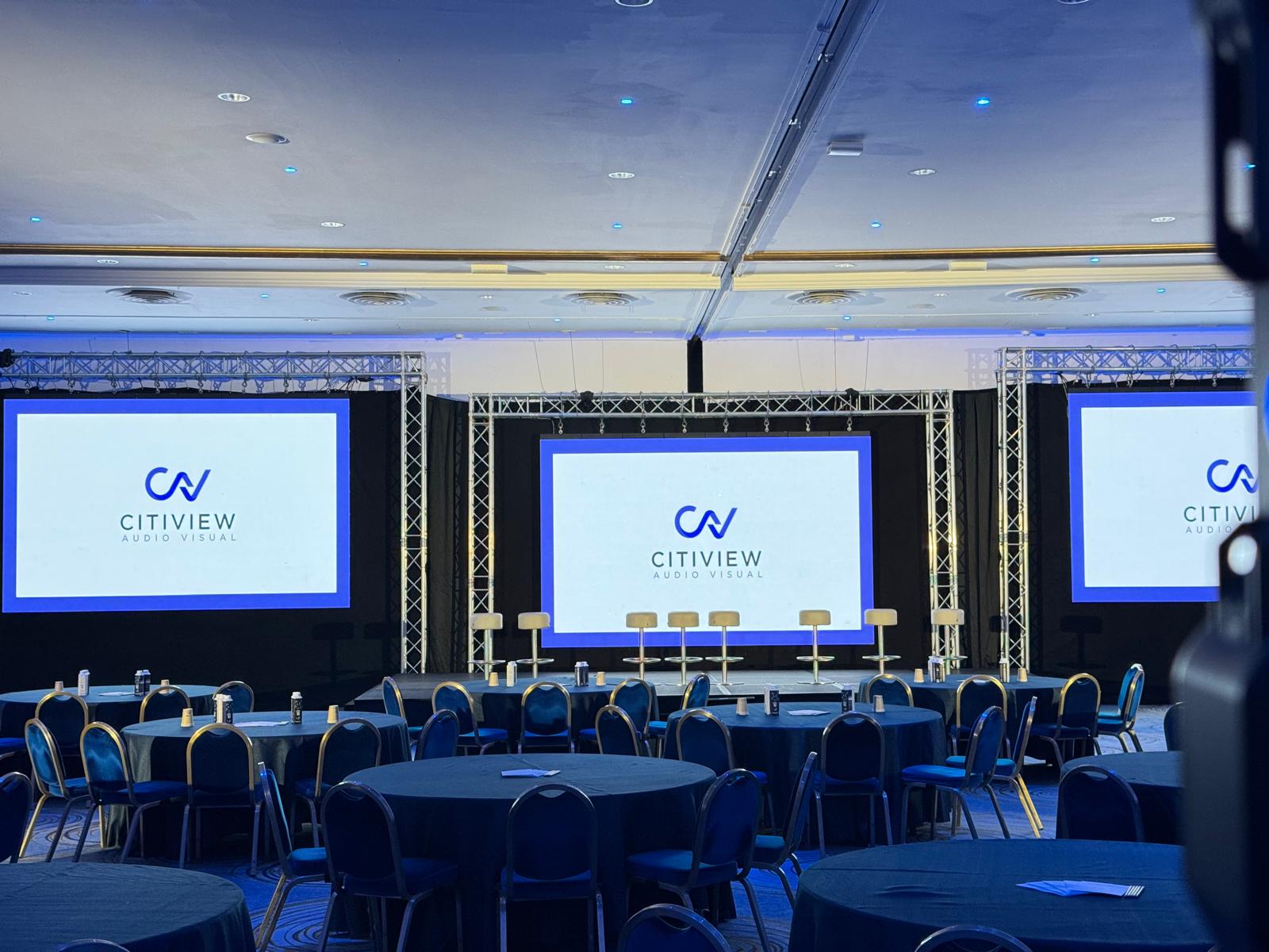 CitiView-branded stage screens on truss in a ballroom