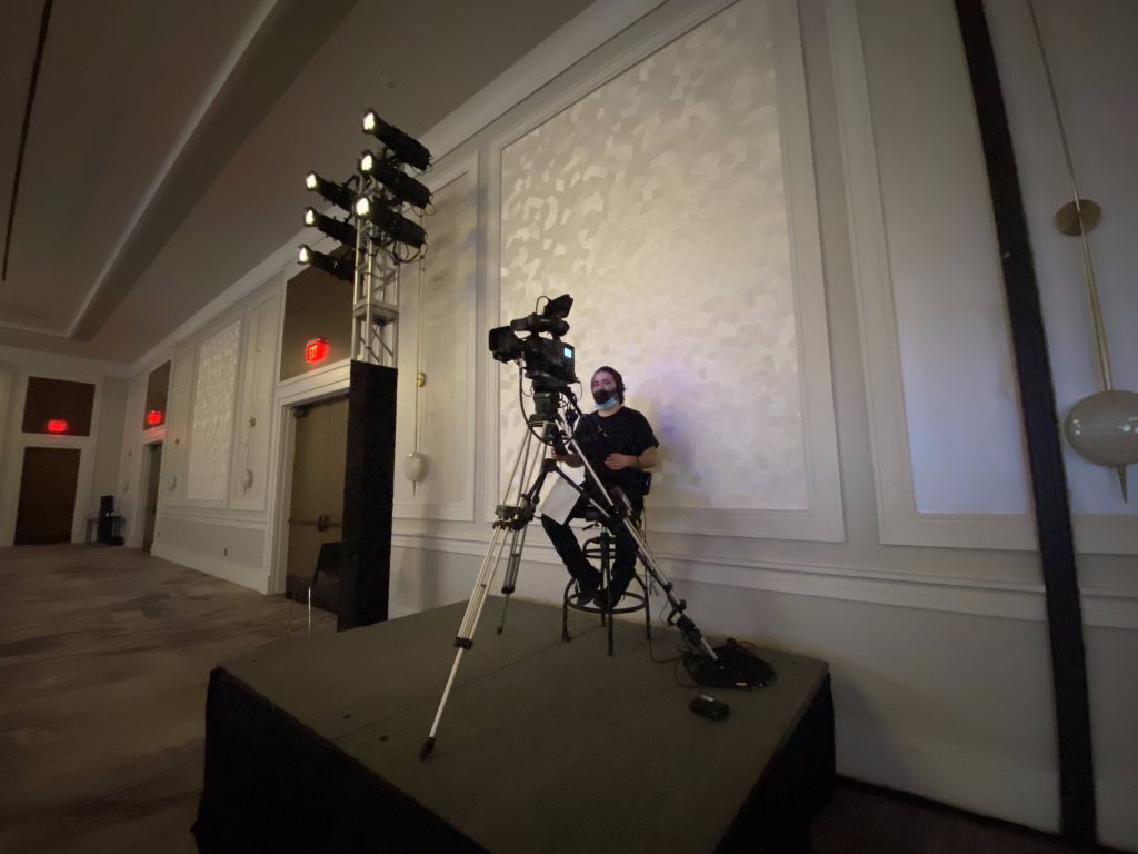 Technical production table with laptops and audio mixer overlooking a ballroom event by CitiView Audio Visual