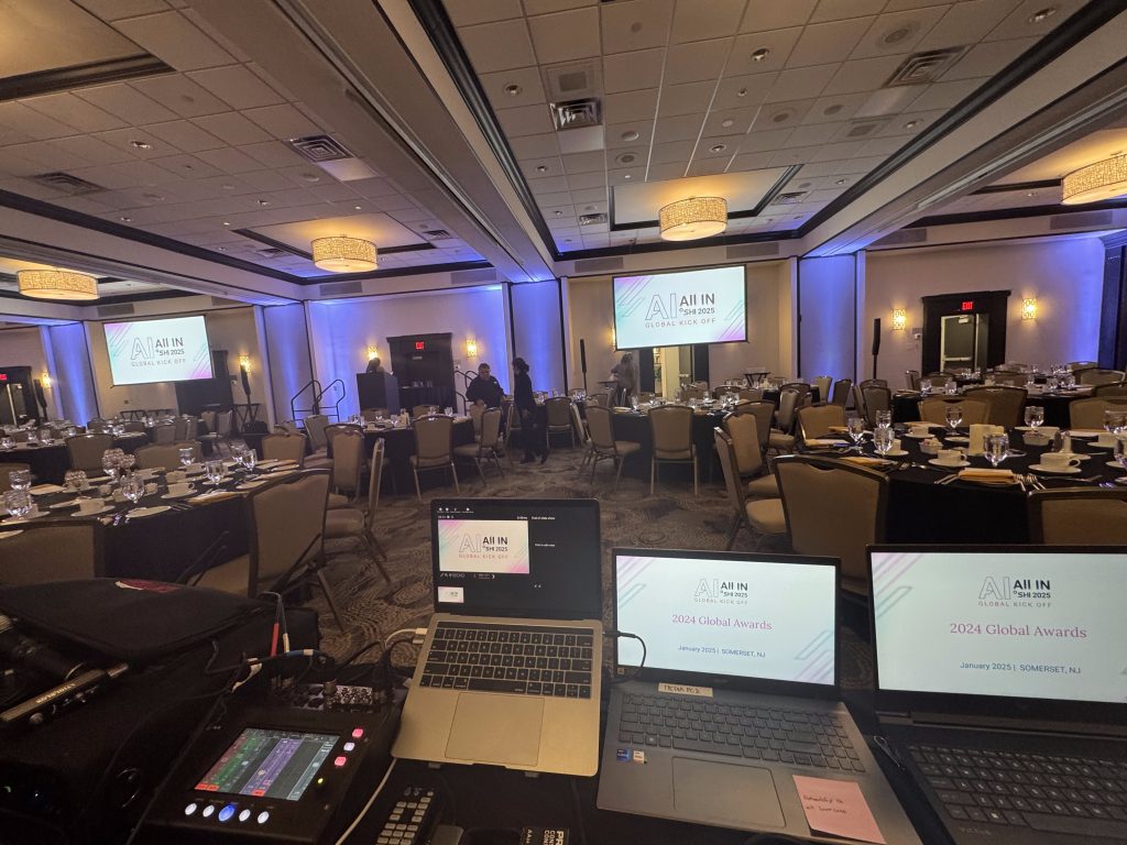 Technical production table with laptops and audio mixer overlooking a ballroom event by CitiView Audio Visual