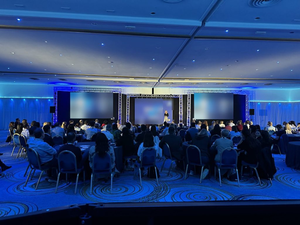 Ballroom general session with three screens on truss produced by CitiView Audio Visual