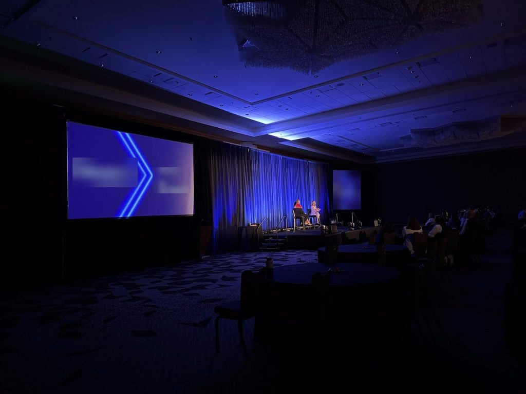 Keynote general session stage with screens and blue lighting by CitiView Audio Visual